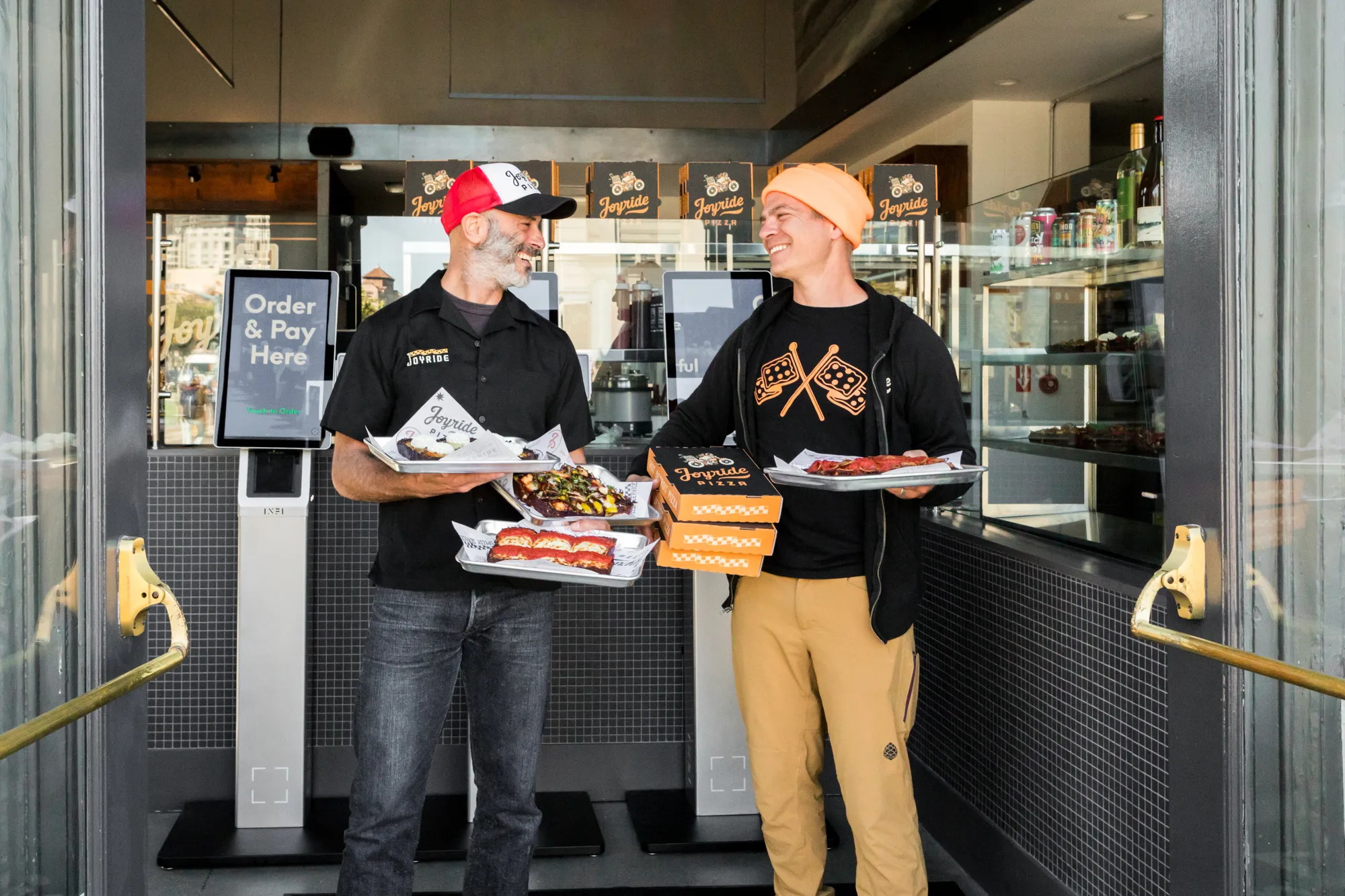 Guests at the Joyride Pizza Pier 1 entrance order-and-pay kiosks