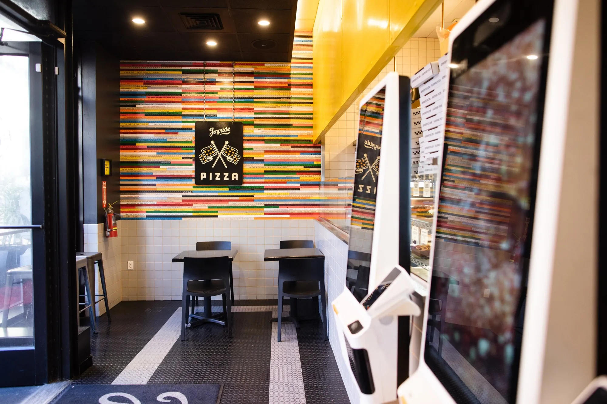 Interior of Joyride Pizza Market Street with self-order kiosks and counter seating