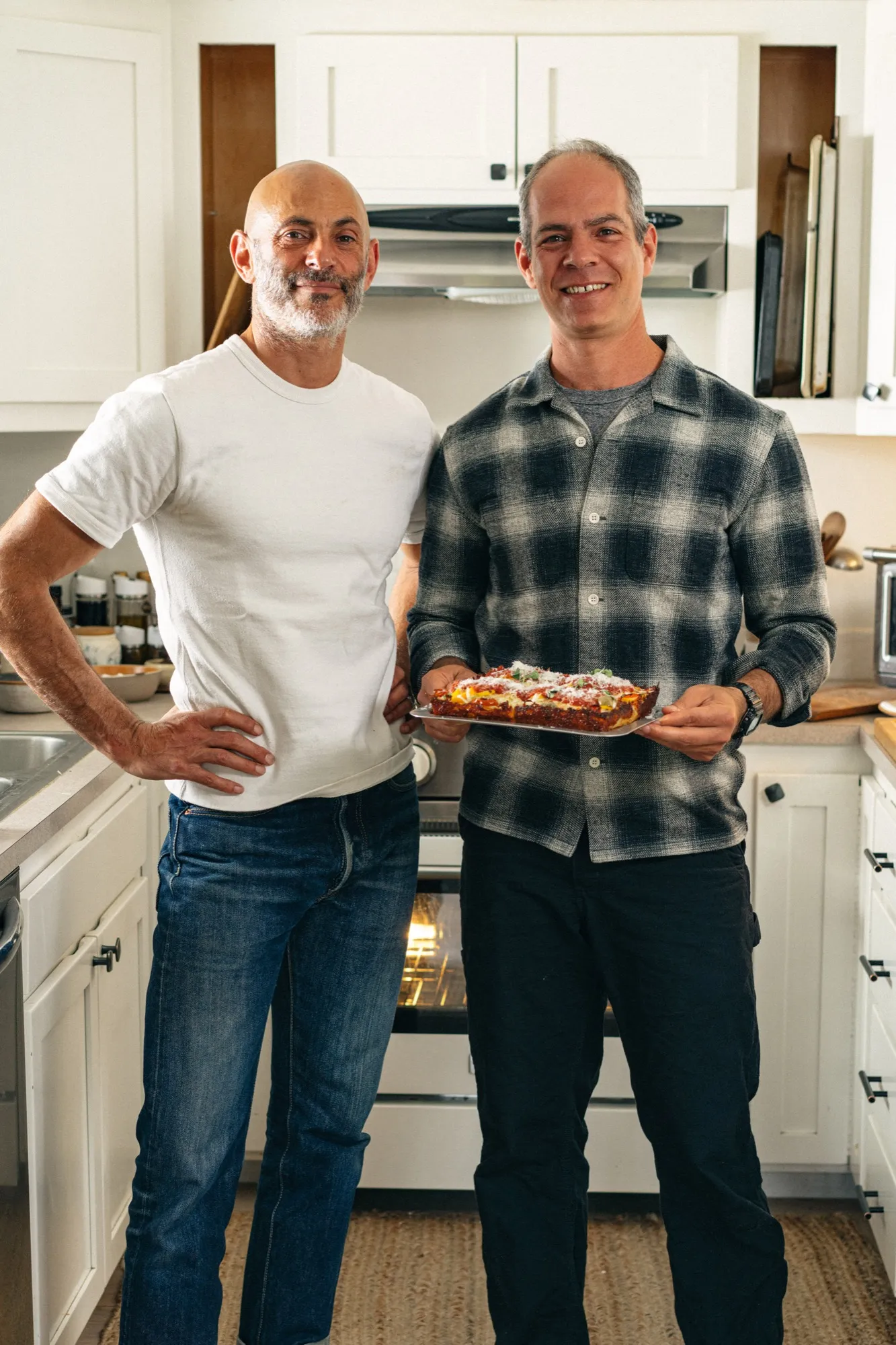Joyride founders Jesse and Josh Jacobs in the kitchen with a fresh Detroit-style pizza